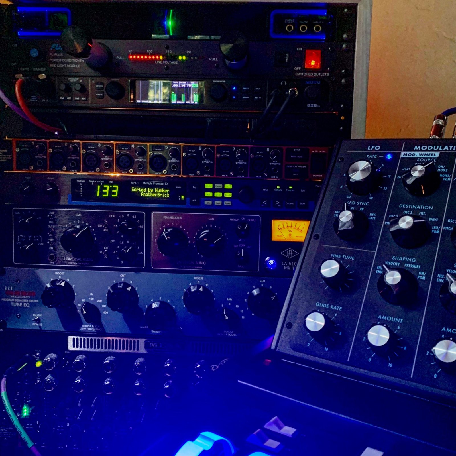 wetwire studio: Moog Voyager with blue illumination alongside Universal Audio outboard, Lexicon MPX1, and MOTU rack